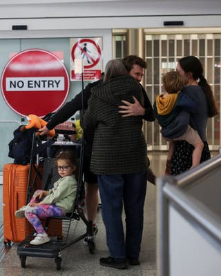 A family reacts as passengers from the first government-chartered flight for British nationals, which departed from Oman, arrive at London Stansted Airport, amid the US-Israeli conflict with Iran, near London, Britain, 6 March 2026